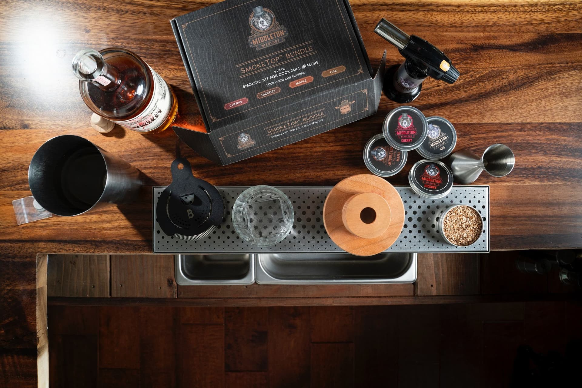 Professional bartender demonstrating the SmokeTop cocktail smoking technique