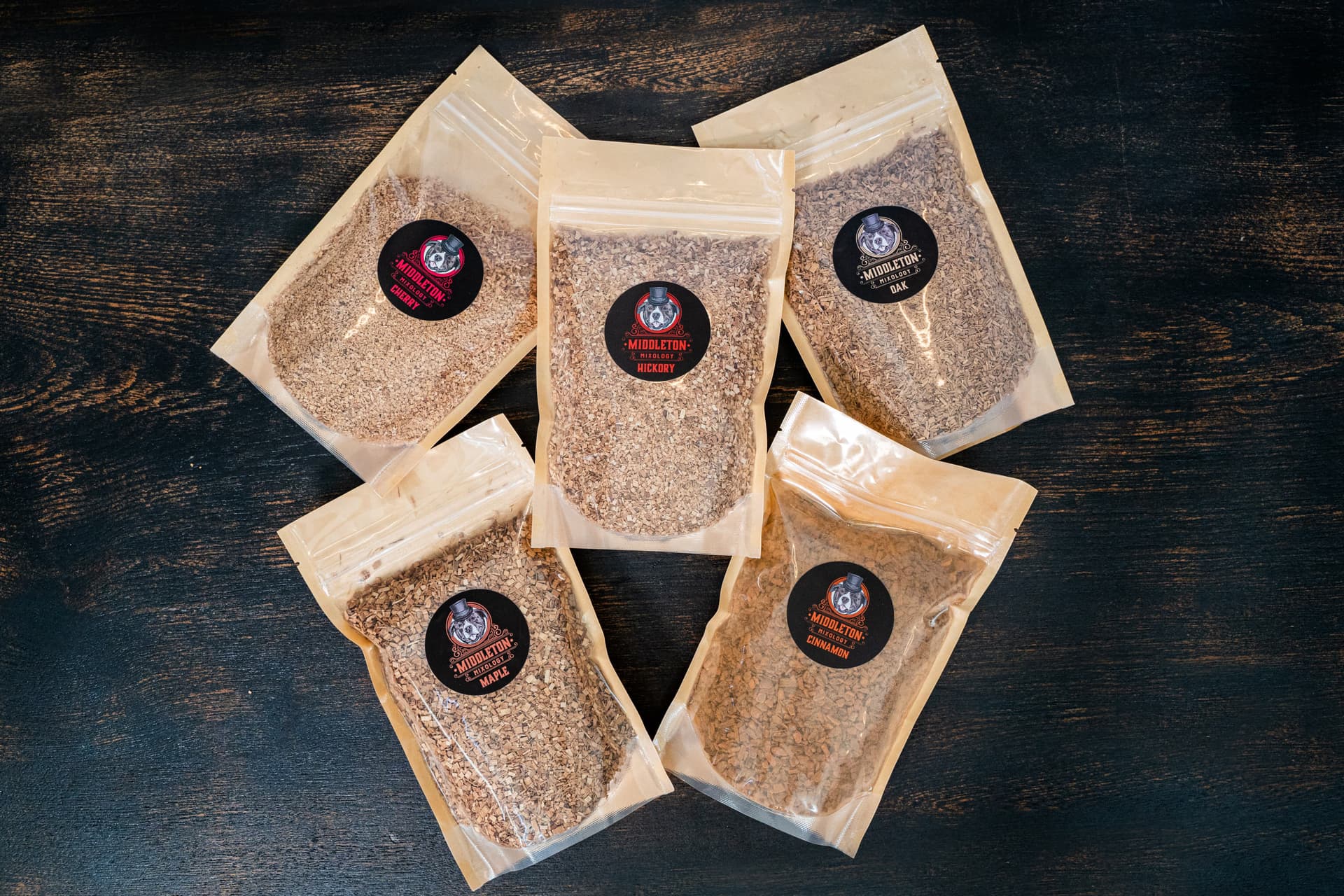 Professional wood chip collection featuring multiple varieties including oak, cherry, apple, and hickory chips for cocktail smoking